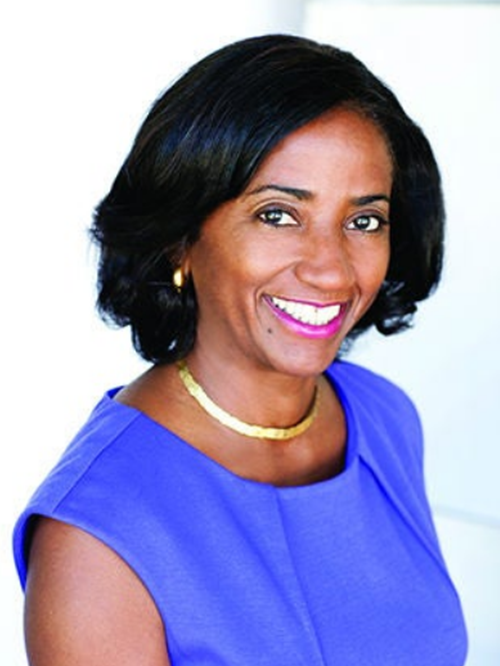 Monique Lawshe smiling in an indoor setting