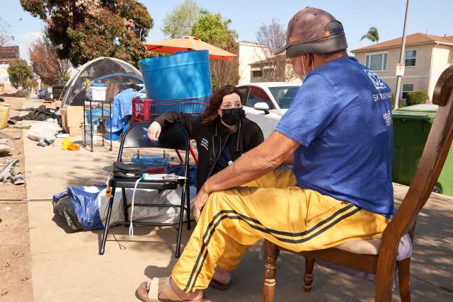 HHC provider treating unhoused man at tent encampment