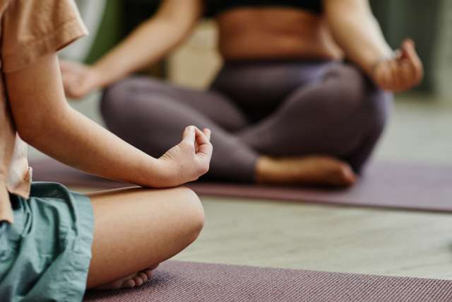Two people meditating on yoga mats