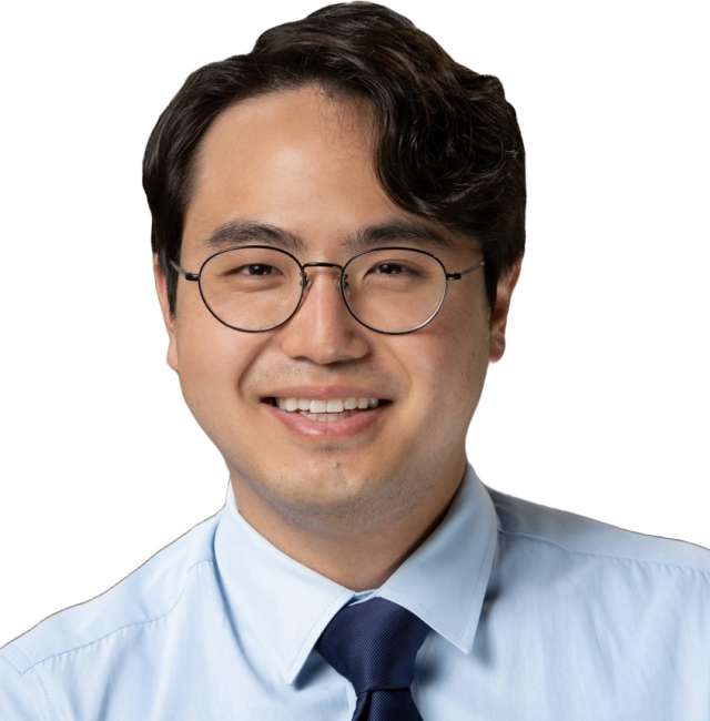Junun Bae in a light blue shirt and dark tie, poised for a professional setting.