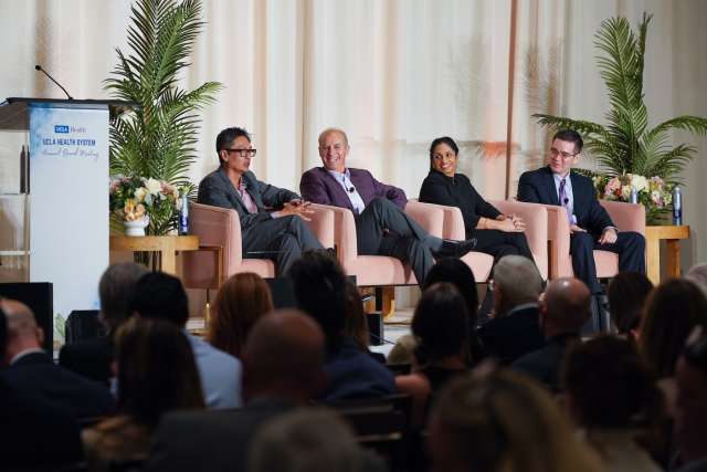 Panelists in front of a crowd