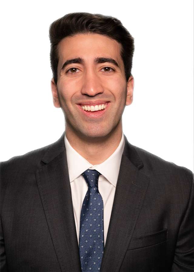 Smiling man in dark suit and tie on white background