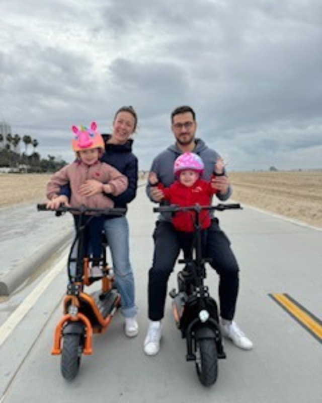Amelia Delaporte, MD, her partner and two kids on electric bicycles.