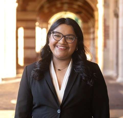 Female doctor student wearing glasses and a dark jacket