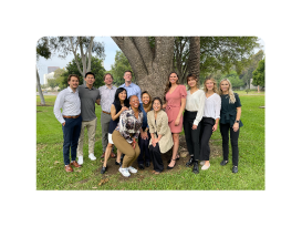 group of PM and R residency program residents outside near a tree