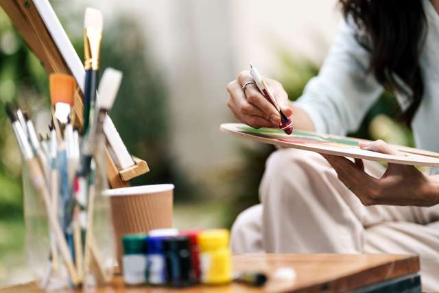 Woman sitting and painting a picture