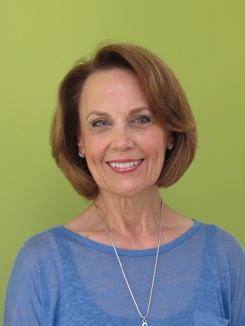 Jan Kern smiling in an indoor setting