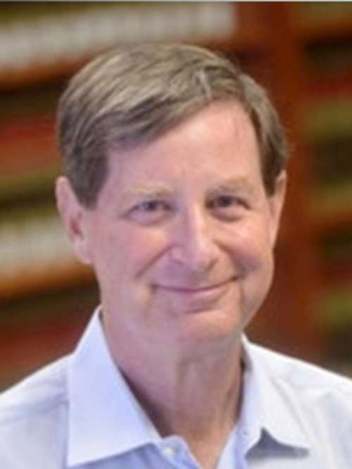 Bob Feldman in front of a set of bookshelves