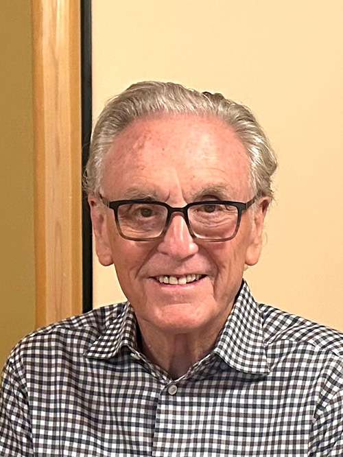 Headshot of Howard Levy smiling in a classroom setting