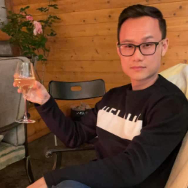 Dr. Hai Pham lounging with a wine glass