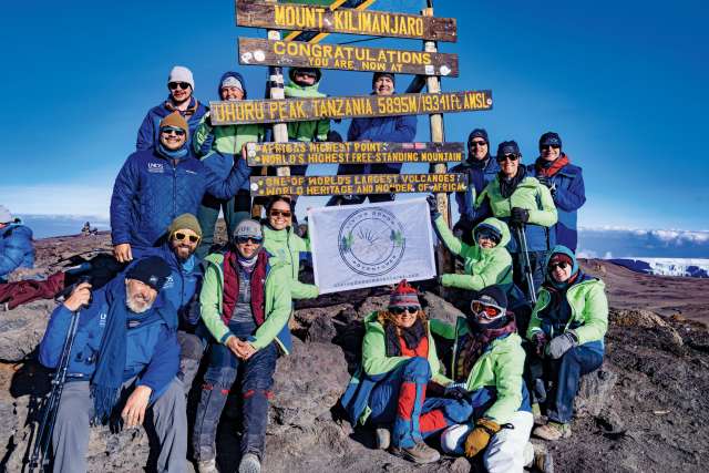 Members of Living Donor Adventures, with whom Dr. H. Albin Gritsch climbed on Mt. Kilimanjaro, celebrate reaching the summit.