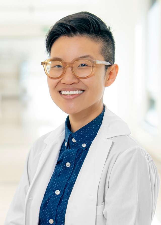 Headshot of Esther Kang, MD in a white Lab Coat