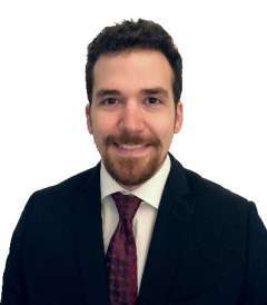 Ethan Pfeifer wearing a white shirt and purple tie.