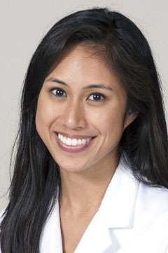 Marielle Bolano wearing a white coat, with long dark hair.