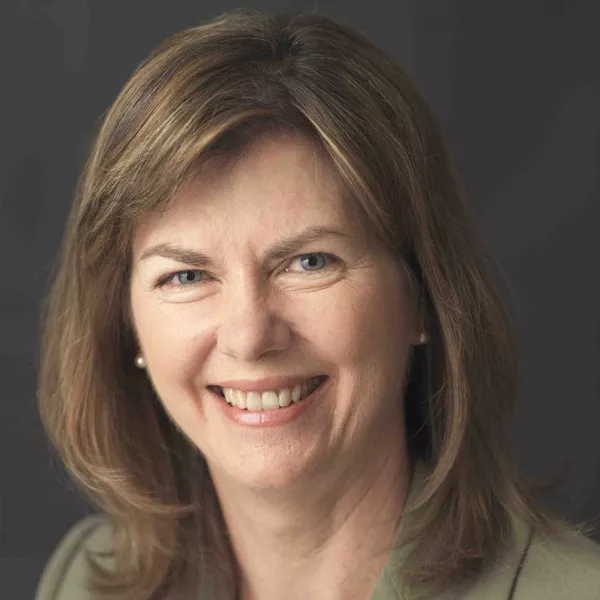 headshot of Linda deer in olive blazer