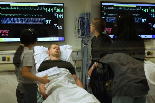 Neurology residents checking vitals during stroke simulation