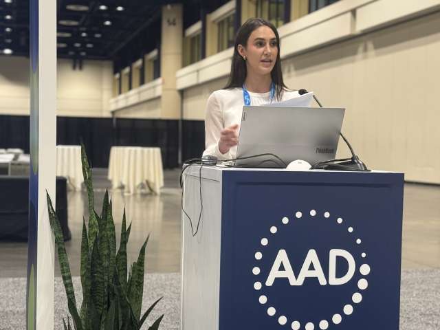 April Armstrong Lab fellow woman on a stand giving a presentation