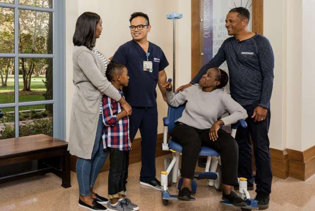 A doctor helping a family through a loved-ones recovery.