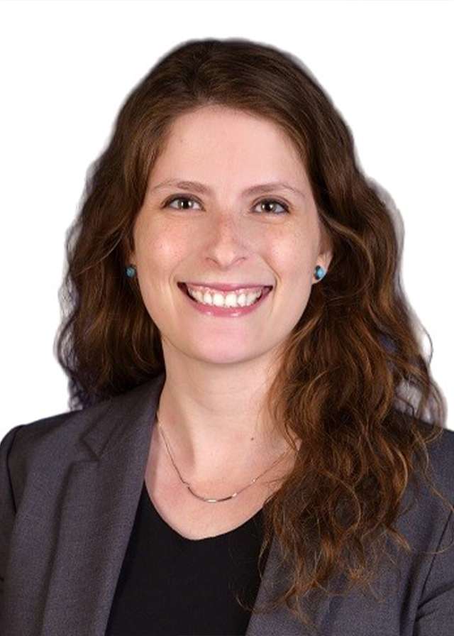Smiling professional woman in gray blazer and black top on white background