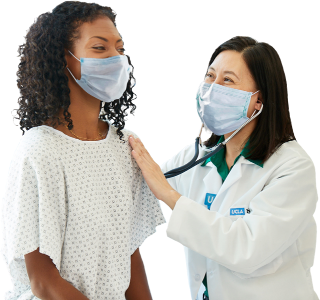 Doctor checking a patient with stethoscope, wearing masks