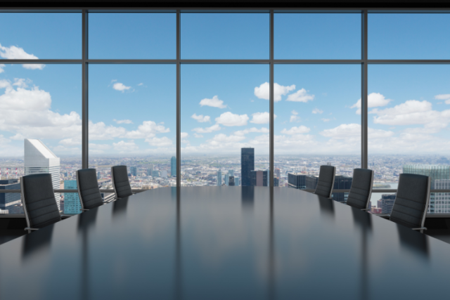 empty large conference room with a big window view of blue skies