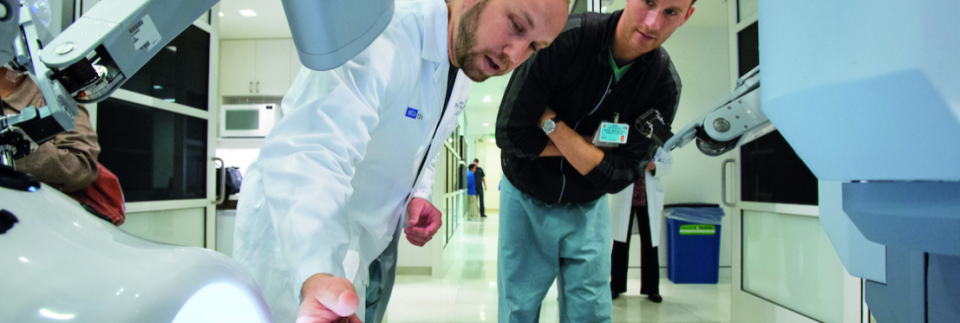 two medical professionals inspecting radiology equipment 