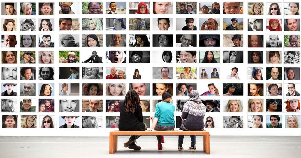 Three people sitting in front of a collage of people of different ethnicities