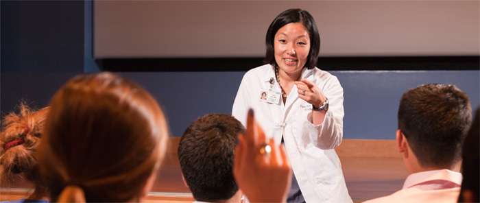 Female doctor lecturing in front of a class
