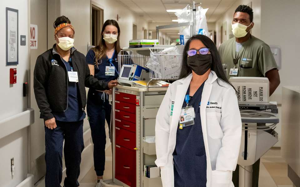 Nurses in hallway with equipment