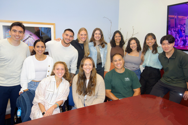 First Year Family Medicine Residents sitting behind a table smiling for the camera