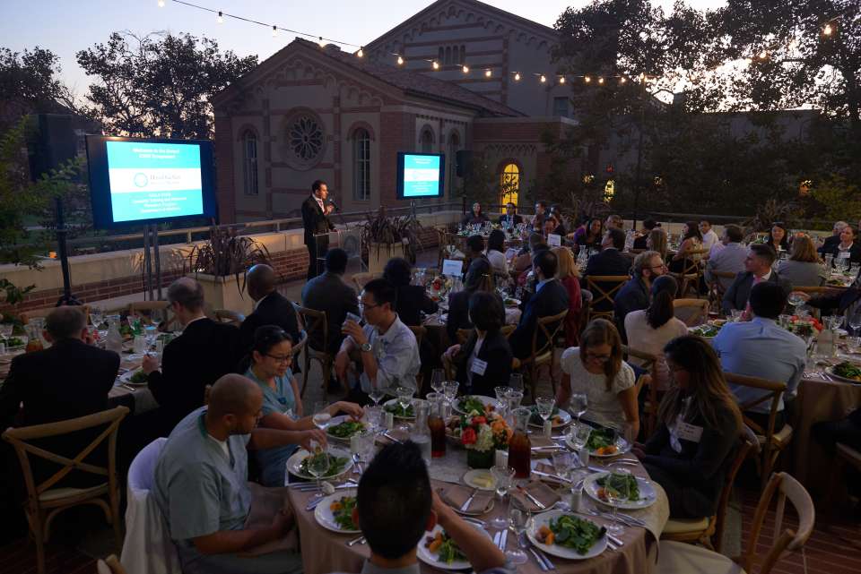 People gathered eating at symposium
