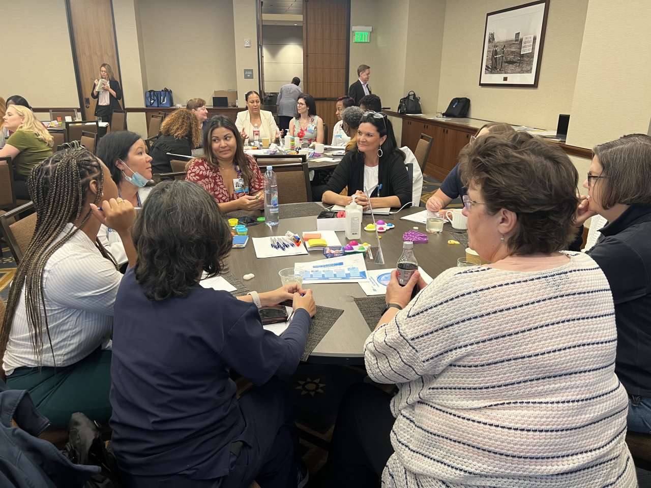 Members of the Nursing Executive Council sit around a conference table engaged in discussion.