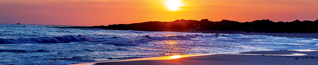 Sunrise over the ocean and mountains