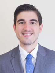 Marcos Estrada Rodriguez, MD headshot, wearing a suit and tie