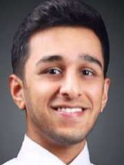 Akash Halgur, a young man with dark hair, smiling confidently at the camera. He wears a white shirt and a patterned tie.
