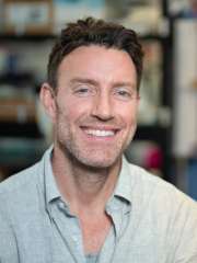 Dr. David Nathanson stands smiling in his lab