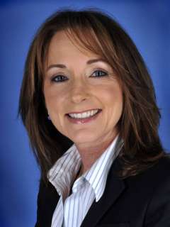 Professional headshot of Dr. Jo Sornborger against a blue background.