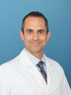 Dr. Kevin Ghassemi wearing white labcoat.