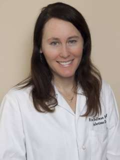 Portrait of person in white lab coat with blurred face