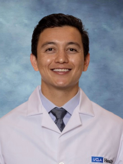 A headshot of a Dr. Michael LoBasso with dark hair, and a warm smile, wearing a white coat and a tie.
