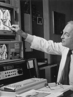 Professor Joseph K. Perloff studying X-ray images