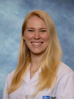 Dr. Fiona Roediger headshot smiling and wearing a white lab coat.