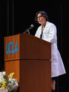 Dr. Jennifer Lucero speaking at the White Coat Ceremony for DGSOM Class of 2026