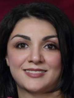 A professional headshot of Dr. Niloofar Nobakht  with dark hair. Her direct gaze and confident smile convey a friendly, approachable, and warm personality.