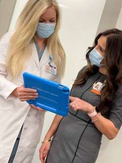 medical personnel looking at iPad