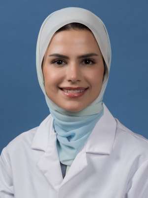 Head shot of Mahdieh Hosseini in white lab coat, smiling at camera