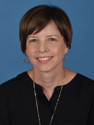 Headshot of libby shin in black blouse