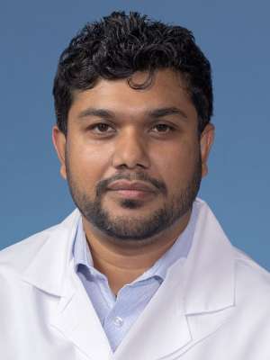 AHM (Zuberi) Ashraf, PhD in a white lab coat