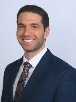 Dr. Michael Bazzi in a dark blue suit