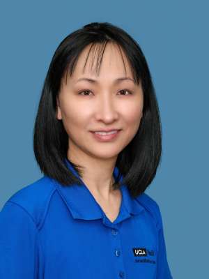 Michelle Tan wearing a blue collared shirt with UCLA logo